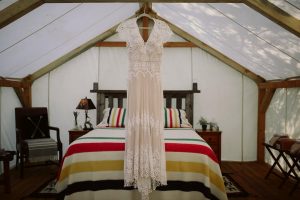 a-brides-bohemian-wedding-dress-hanging-inside-the-canvas-rtent-before-her-wilderness-wedding