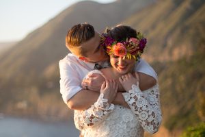 happy-boho-bride-and-groom-she-wears-a-vibrant-flower-crown-and-crochet-long-sleeve-wedding-dress