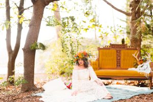 boho-bride-wearing-a-colorful-flower-crown-and-a-bell-sleeve-hippie-lace-dress