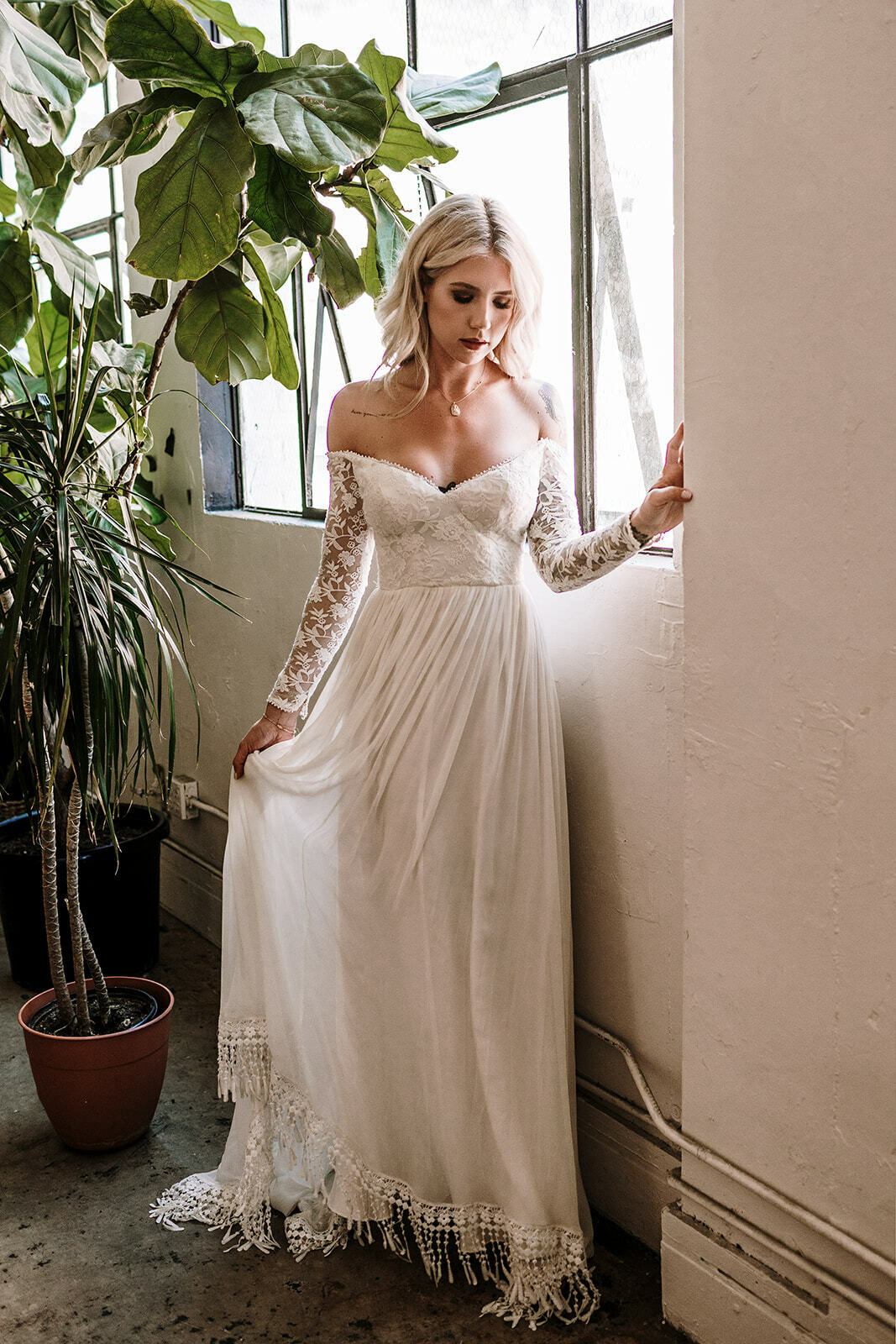white lace off the shoulder wedding dress