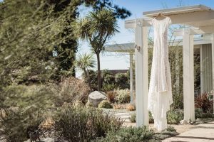 wedding-dress-on-hanger-for-a-backyard-wedding